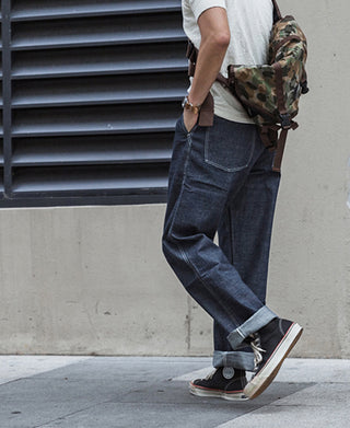Indigo denim fatigue pants with front slash pockets and tapered legs