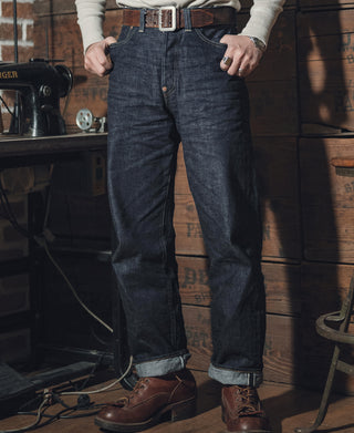 Dark indigo denim jeans with belt loops and straight legs