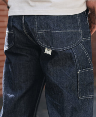 Indigo denim painter pants, side cargo pocket with stitching and size tag