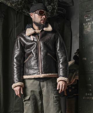 Dark brown leather zip-up flight jacket with cream shearling cuffs and collar trim