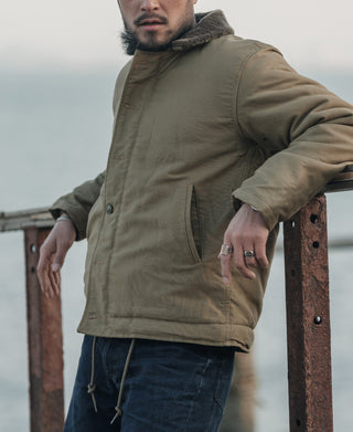 Khaki deck jacket on model with buttoned front and fur-lined collar