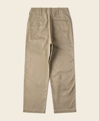 Tan chino trousers laid flat, straight legs and centered front seam