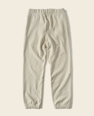 Light cream sweatpants, front view; drawstring pocket and ribbed ankle cuffs