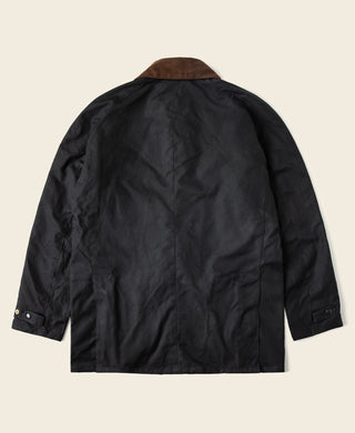 Back view of black waxed chore jacket with brown collar lining
