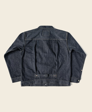Indigo denim jacket with front button closure and two chest flap pockets.