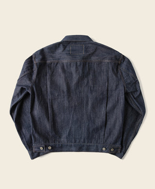 Indigo denim jacket back view with buttoned cuffs and central yoke seam