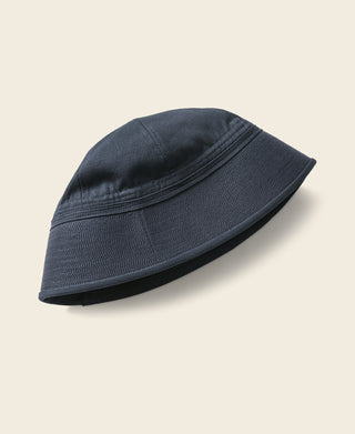 Navy Dixie Cup cap with short brim and curved crown, side view