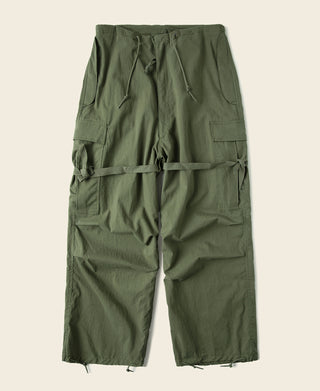 Olive utility trousers with front drawstring and cargo pockets; adjustable thigh strap