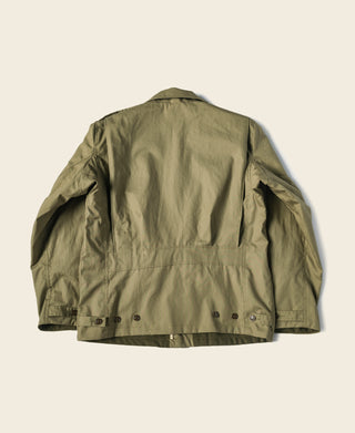 Olive green field jacket back view with button placket and adjustable hem