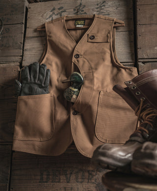 Khaki canvas hunting vest with flap pockets, button front, and sturdy stitching