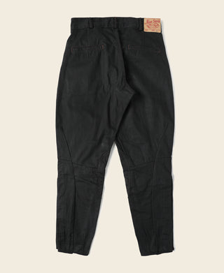 Black riding breeches with dark waistband, tapered leg, and buttoned cuffs