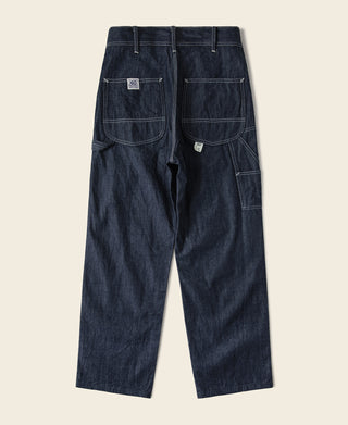 Indigo denim painter pants with bib-style patch pockets and back yoke