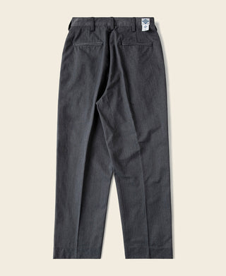 Dark gray double-pleated chino trousers with side pockets and back yoke