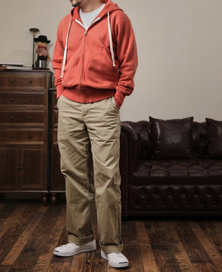 Brick red terry cloth full-zip hoodie with hood and drawstring, front pockets visible