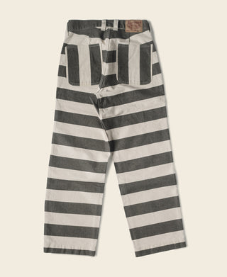Wide striped prisoner pants with white and black horizontal stripes and elastic waist.
