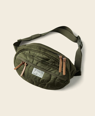 Olive waist bag with curved front pocket, zipper and tan leather-style pulls