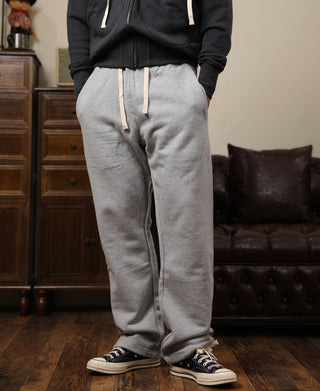 Gray terry sweatpants with tapered legs, drawstring waist, and side pockets