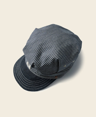 Railroad engineer cap in navy-and-white stripe fabric with dark curved brim