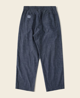 Indigo chambray pants with double pleats and relaxed straight leg silhouette