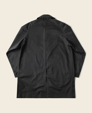 Black all-weather trench coat, back view with center seam and vent