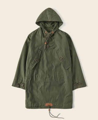 Olive cotton field parka laid flat, hooded pullover with front snap placket