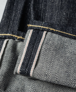 Indigo selvedge denim jeans pocket seam with red-striped interior binding