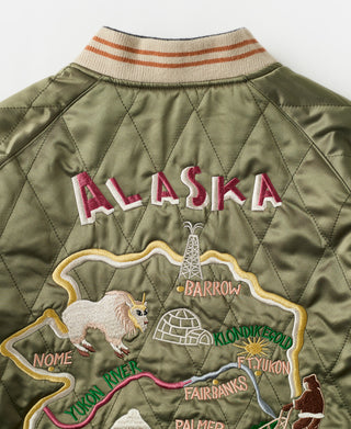 Back of olive reversible souvenir jacket with embroidered "ALASKA" and town map patches