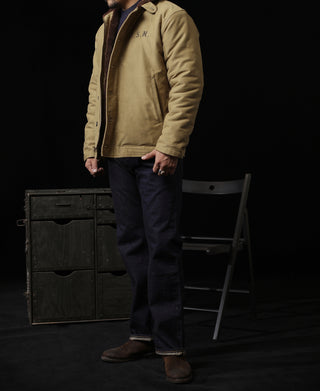 Khaki deck jacket worn with dark jeans; brown sherpa collar and zip-less snap front