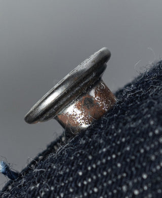 Indigo denim jacket metal snap button at edge with copper finish