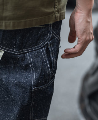 Indigo denim pocket panel with contrast stitching and textured slub finish