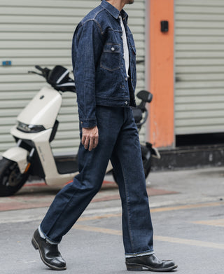 Indigo selvedge denim jeans on model, button fly, straight leg, rolled cuffs