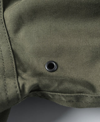 Olive flight jacket snap button on inner placket, close-up