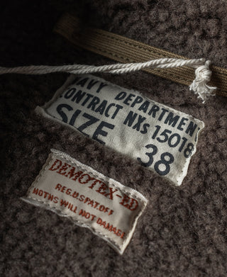 Khaki deck jacket label detail with stitched patch and rope drawstring