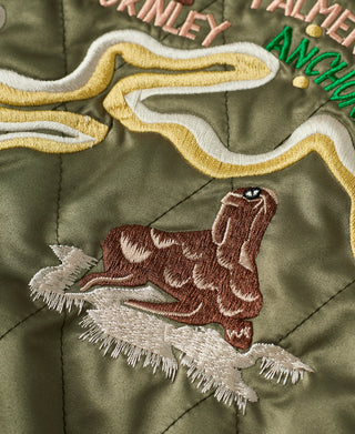 Embroidered walrus patch on olive quilted reversible jacket