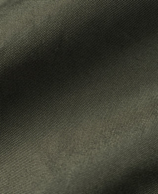 Olive flight jacket fabric texture close-up.