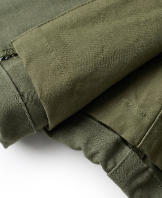 Olive field jacket sleeve cuff with adjustable strap tab