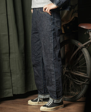 Indigo selvedge denim jeans, loose straight fit, button fly detail, side view