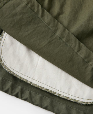 Olive field jacket interior hem with visible zipper stitching