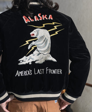 Black reversible souvenir jacket worn with Alaska eagle graphic and “America’s Last Frontier” text.