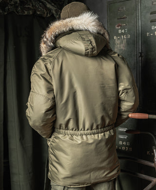 Olive Type N-3 parka on model, back view with knit hood cover and fur trim