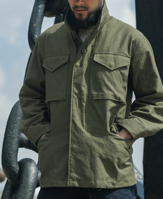 Olive field jacket with flap chest pockets, button front, and stand collar.