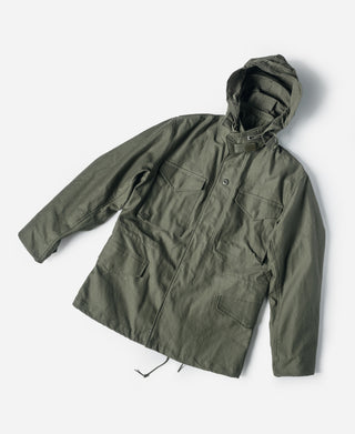 Olive field jacket with attached hood, button front, and chest flap pockets.