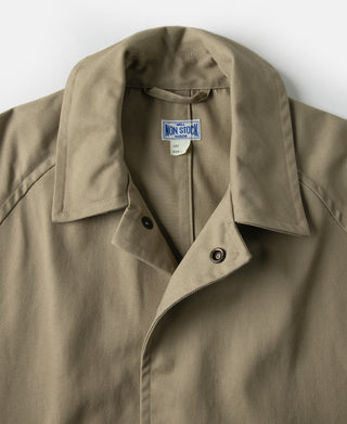 Khaki trench coat collar with snap tab and interior label at neckline