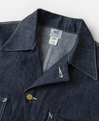 Indigo denim jacket close-up of collar, inner placket, and gold button with logo patch