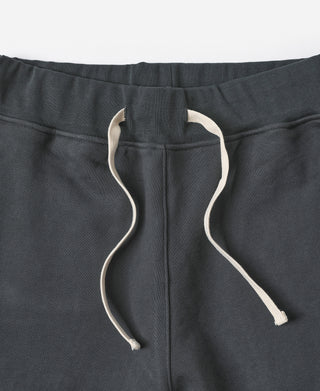 Black terry sweatpants waistband with white drawstrings and elastic top