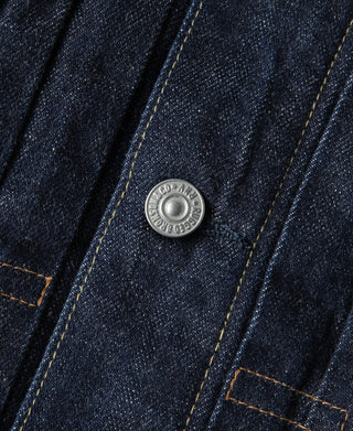 Denim jacket snap button with contrast orange stitching and seam detail