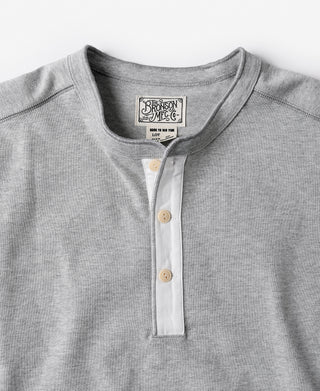 Gray henley shirt neckline with short button placket and small chest label