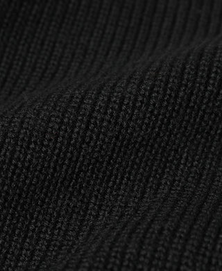 Black ribbed knit fabric close-up with textured weave pattern