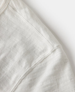 White henley t-shirt sleeve with stitched seam detail near the shoulder
