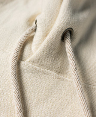 Apricot hoodie kangaroo pocket seam detail.